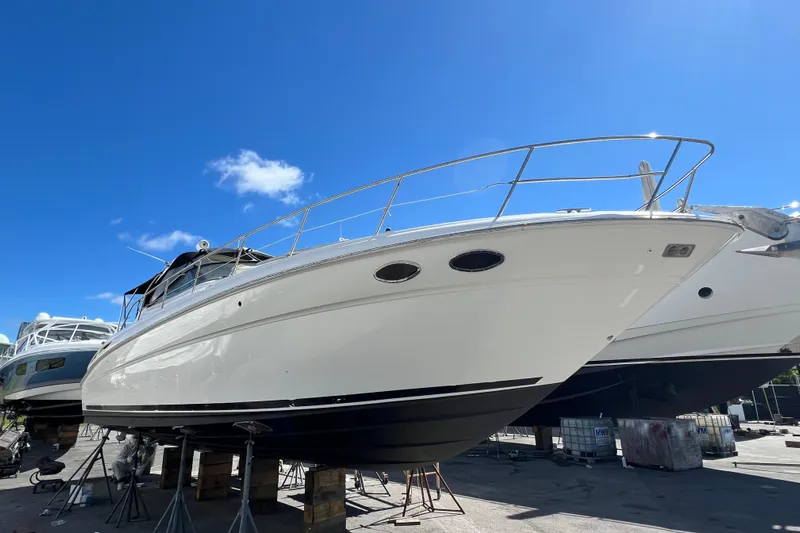 Genesis Yacht Photos Pics 2003 Sea Ray 380 Sundancer yacht on dry dock under clear blue sky.