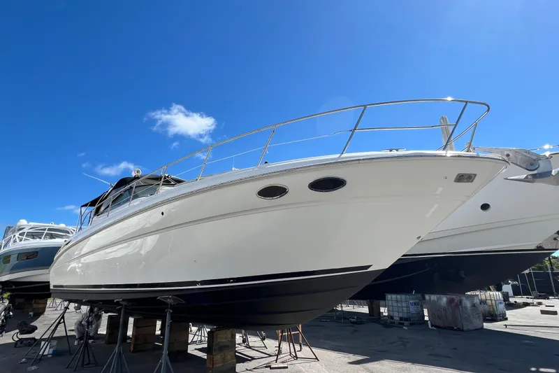 Genesis Yacht Photos Pics 2003 Sea Ray 380 Sundancer yacht on dry dock under clear blue sky.