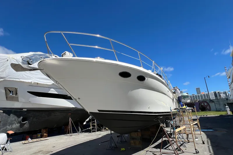 Genesis Yacht Photos Pics 2003 Sea Ray 380 Sundancer yacht on dry dock under clear blue sky.