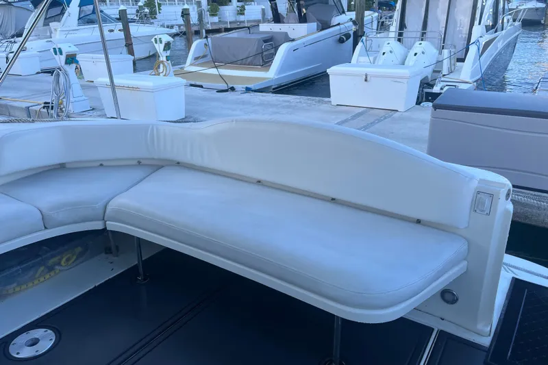 Genesis Yacht Photos Pics 2003 Sea Ray 380 Sundancer boat with white seating at a marina.