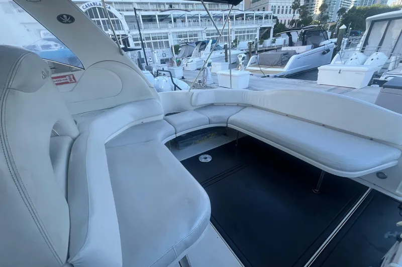 Genesis Yacht Photos Pics 2003 Sea Ray 380 Sundancer yacht interior with white seating at marina.