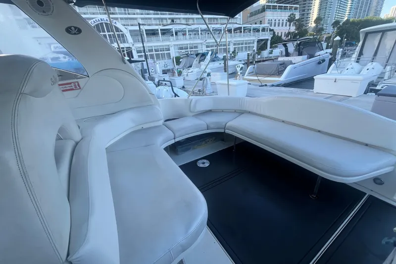 Genesis Yacht Photos Pics Luxurious seating area on a 2003 Sea Ray 380 Sundancer yacht at a marina.