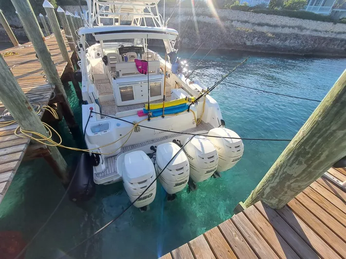 The Reel Deal Yacht Photos Pics 2016 Boston Whaler 420 Outrage docked, featuring four powerful outboard engines.