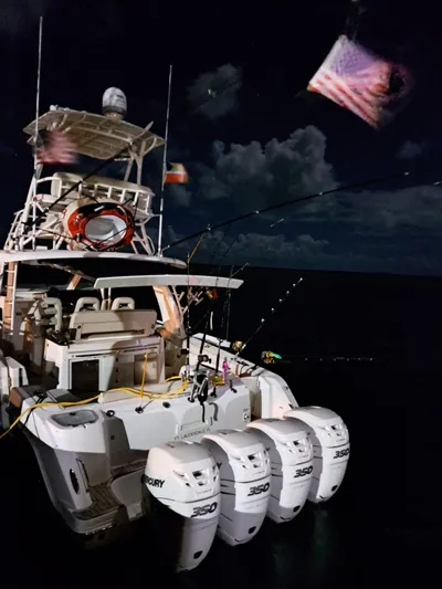 The Reel Deal Yacht Photos Pics 2016 Boston Whaler 420 Outrage boat with four Mercury 350 engines at night.