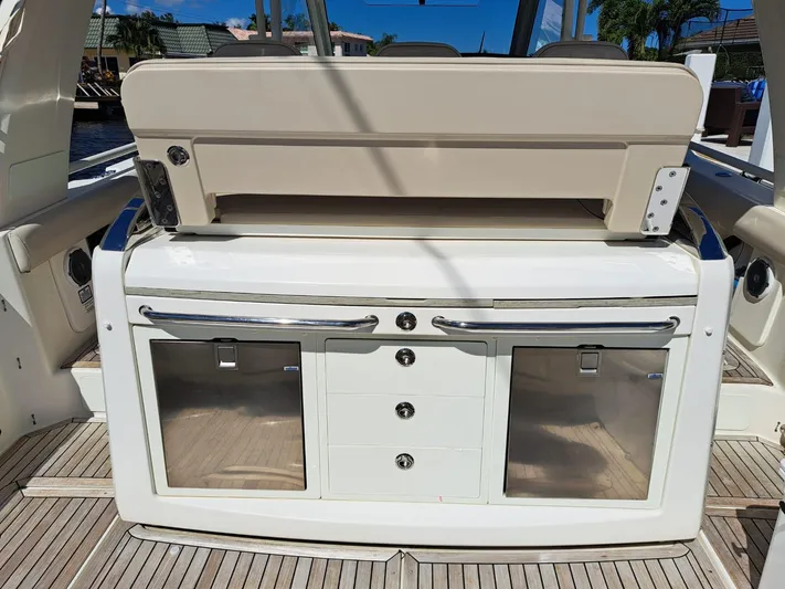 The Reel Deal Yacht Photos Pics 2016 Boston Whaler 420 Outrage boat interior with storage compartments and seating.