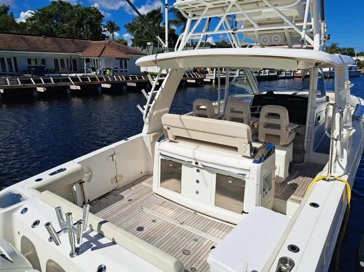 The Reel Deal Yacht Photos Pics 2016 Boston Whaler 420 Outrage boat docked by waterfront homes.