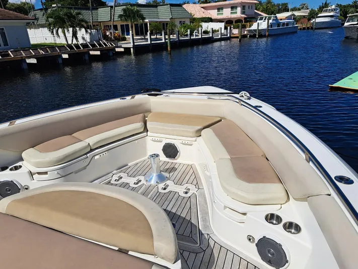 The Reel Deal Yacht Photos Pics 2016 Boston Whaler 420 Outrage boat with spacious seating docked in a marina.