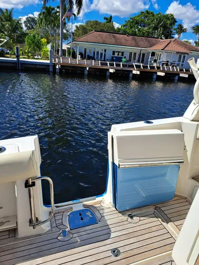The Reel Deal Yacht Photos Pics Boston Whaler 420 Outrage 2016 boat docked by waterfront home with wooden deck.