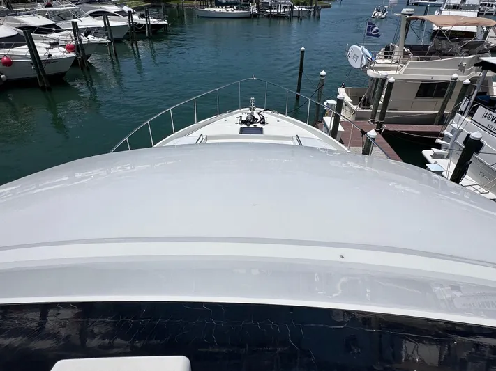  Yacht Photos Pics 2004 Cheoy Lee 68 yacht docked at marina, surrounded by other boats.