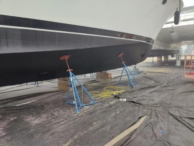  Yacht Photos Pics Cheoy Lee 68 yacht from 2004 on stands for maintenance in a shipyard.