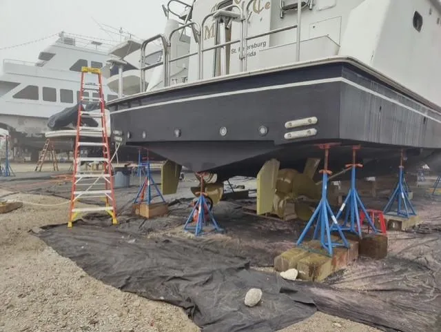  Yacht Photos Pics Cheoy Lee 68 yacht from 2004 on stands for maintenance in a shipyard.