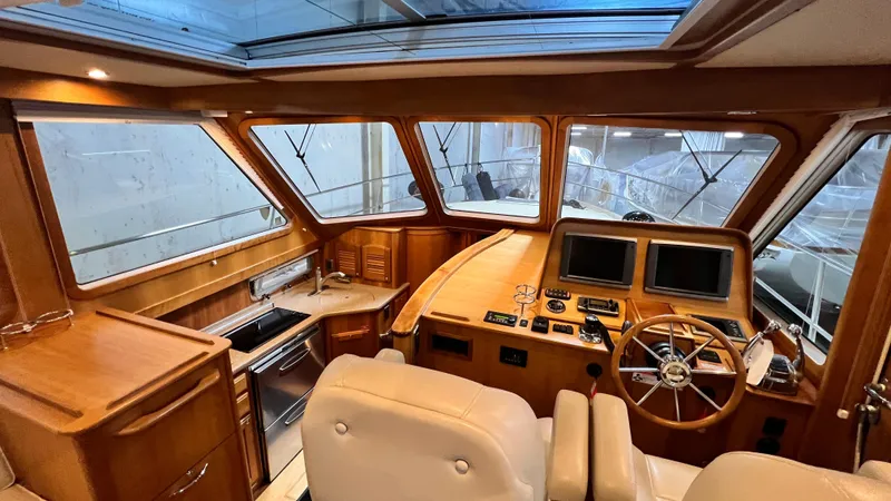 Tempest Yacht Photos Pics Interior of 2011 Sabre 40 Sedan yacht with wooden finish and modern controls.