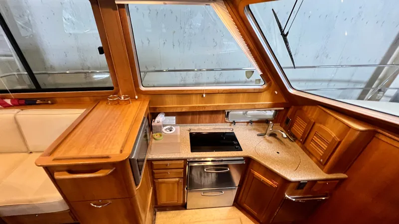 Tempest Yacht Photos Pics Interior of 2011 Sabre 40 Sedan yacht kitchen with wood cabinetry and modern appliances.