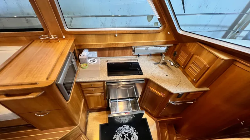 Tempest Yacht Photos Pics 2011 Sabre 40 Sedan yacht kitchen with wood cabinetry and modern appliances.