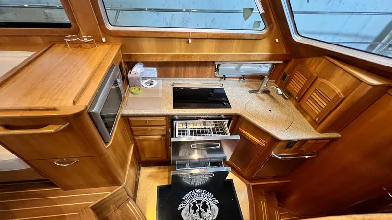 Tempest Yacht Photos Pics 2011 Sabre 40 Sedan kitchen with wood cabinetry, stove, and sink.