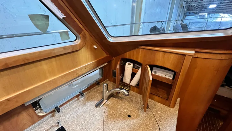 Tempest Yacht Photos Pics 2011 Sabre 40 Sedan interior with wooden cabinetry and sink.