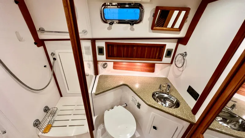 Tempest Yacht Photos Pics Luxurious bathroom in 2011 Sabre 40 Sedan yacht with modern fixtures and wood accents.