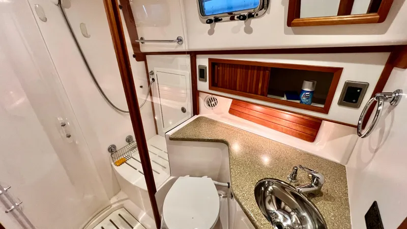 Tempest Yacht Photos Pics 2011 Sabre 40 Sedan bathroom with shower, sink, and storage cabinets.