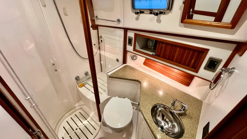 Tempest Yacht Photos Pics Luxurious 2011 Sabre 40 Sedan yacht bathroom with modern fixtures and wood accents.