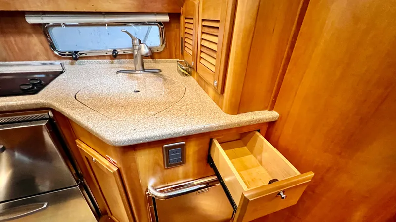 Tempest Yacht Photos Pics 2011 Sabre 40 Sedan kitchen with wood cabinetry and stainless steel appliances.