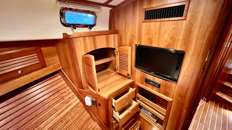 Tempest Yacht Photos Pics 2011 Sabre 40 Sedan interior with wood cabinetry and mounted TV.