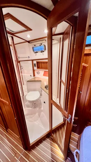 Tempest Yacht Photos Pics Interior of 2011 Sabre 40 Sedan yacht bathroom with wooden accents and modern fixtures.
