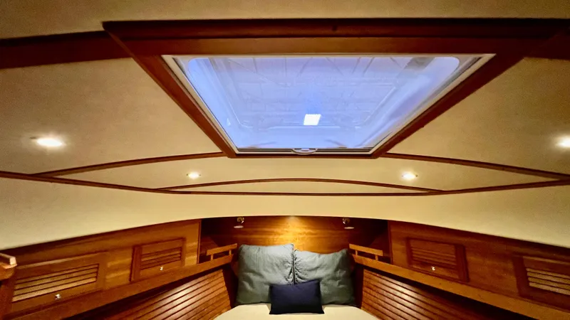 Tempest Yacht Photos Pics Interior of 2011 Sabre 40 Sedan, featuring a cozy cabin with skylight and wooden accents.
