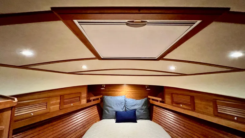 Tempest Yacht Photos Pics Luxurious 2011 Sabre 40 Sedan cabin with wood paneling and cozy bedding.