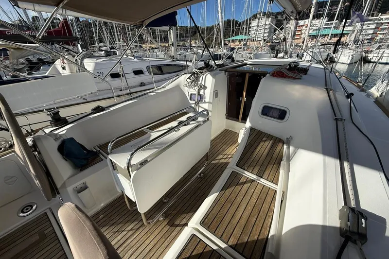 Marine Services S.a.s. Di Berruto Claudia Yacht Photos Pics 2017 Jeanneau Sun Odyssey 349 sailboat cockpit with wooden deck, docked in marina.