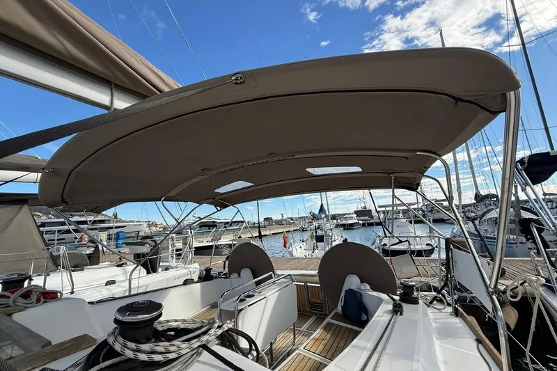 Marine Services S.a.s. Di Berruto Claudia Yacht Photos Pics 2017 Jeanneau Sun Odyssey 349 sailboat cockpit with canopy, docked at marina under blue sky.
