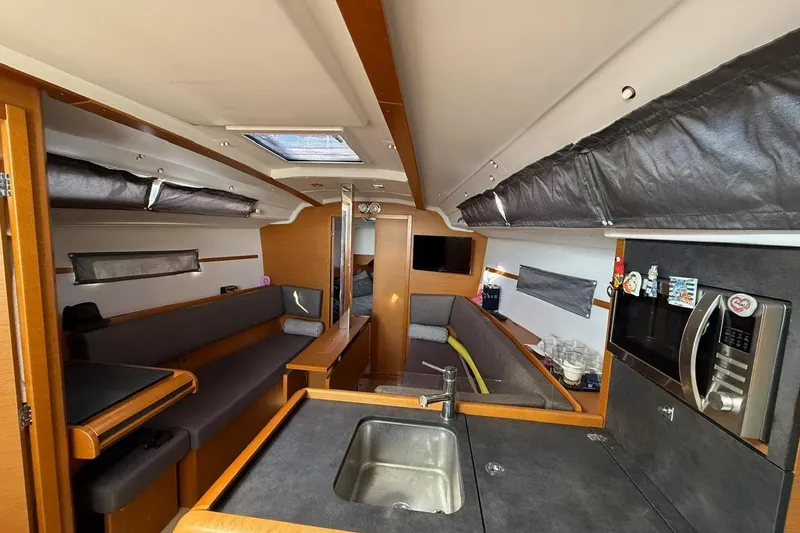 Marine Services S.a.s. Di Berruto Claudia Yacht Photos Pics Interior of 2017 Jeanneau Sun Odyssey 349 sailboat with modern kitchen and seating area.