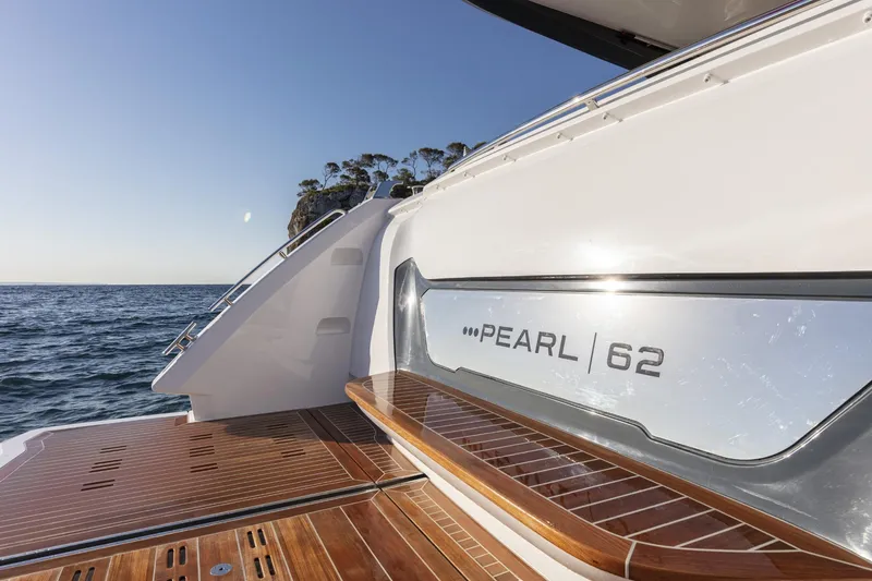 Bahari Yacht Photos Pics Luxury Pearl 62 yacht, 2020 model, with sleek design and wooden deck, on open sea.