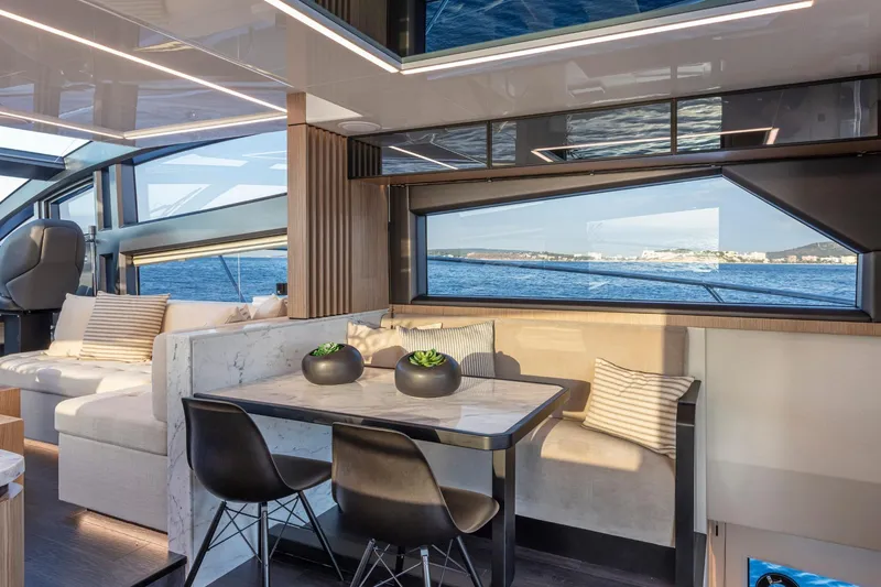 Bahari Yacht Photos Pics Luxurious interior of 2020 Pearl 62 yacht with ocean view and modern seating.