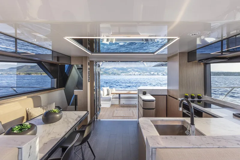 Bahari Yacht Photos Pics Luxurious interior of 2020 Pearl 62 yacht with modern kitchen and ocean view.