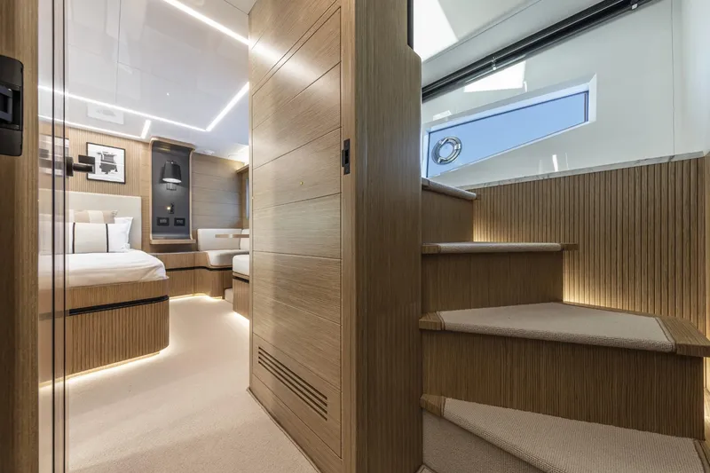 Bahari Yacht Photos Pics Luxurious interior of 2020 Pearl 62 yacht with modern wood finishes and elegant lighting.