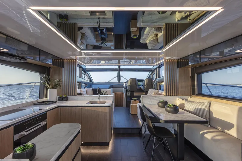 Bahari Yacht Photos Pics Luxurious interior of 2020 Pearl 62 yacht with modern kitchen and dining area.
