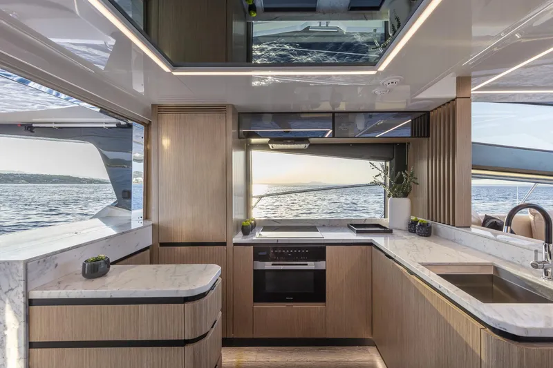 Bahari Yacht Photos Pics Luxurious kitchen interior on 2020 Pearl 62 yacht with ocean view.