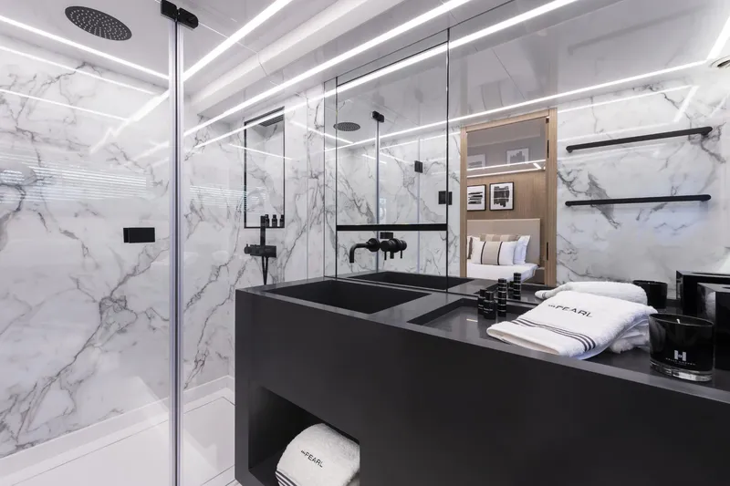 Bahari Yacht Photos Pics Luxurious Pearl 62 yacht bathroom with marble walls and modern black fixtures, 2020 model.