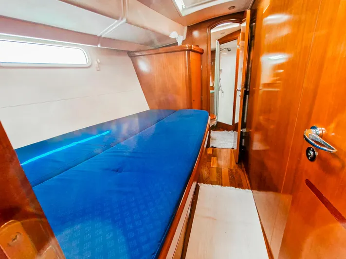  Yacht Photos Pics Luxurious cabin interior of a 2004 Beneteau 57 yacht with blue bedding.