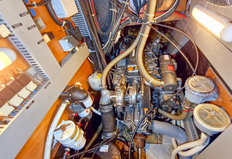  Yacht Photos Pics Engine room of a 2004 Beneteau 57 yacht, showcasing complex machinery and wiring.
