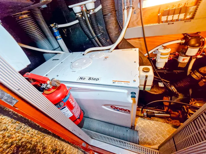  Yacht Photos Pics Engine room of 2004 Beneteau 57 yacht with generator and fire extinguisher.