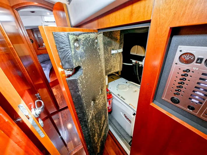  Yacht Photos Pics Interior view of a 2004 Beneteau 57 yacht showing a storage compartment and control panel.