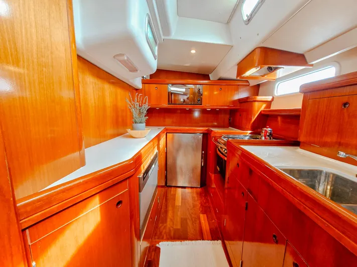  Yacht Photos Pics Luxurious wooden interior of a 2004 Beneteau 57 yacht kitchen.
