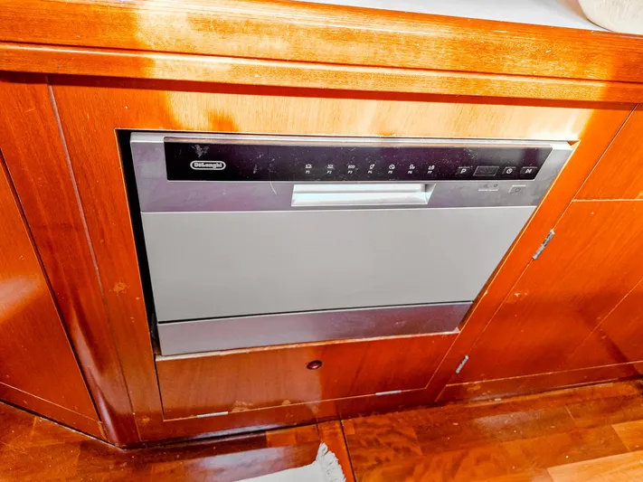  Yacht Photos Pics Built-in dishwasher on 2004 Beneteau 57 yacht, featuring sleek wood cabinetry.