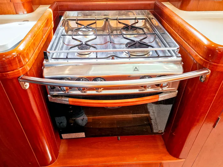  Yacht Photos Pics Stainless steel stove in 2004 Beneteau 57 yacht kitchen with wooden cabinetry.