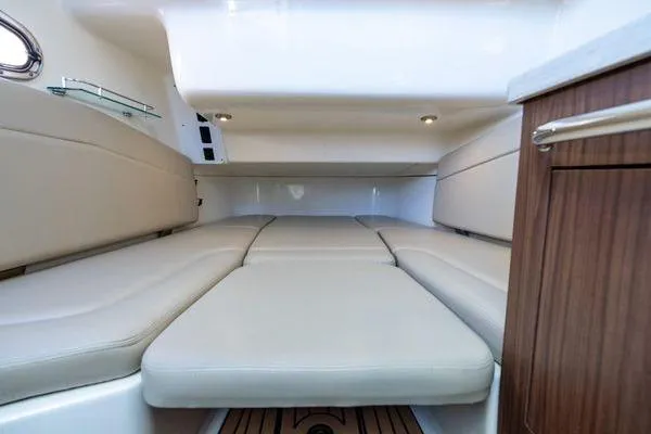  Yacht Photos Pics 2018 Boston Whaler 350 Outrage cabin interior with beige seating and wood accents.