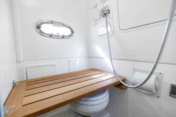  Yacht Photos Pics 2018 Boston Whaler 350 Outrage bathroom with wooden seat and showerhead.