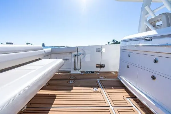  Yacht Photos Pics 2018 Boston Whaler 350 Outrage boat interior with teak flooring and white seating.