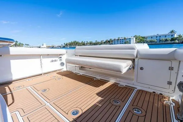  Yacht Photos Pics 2018 Boston Whaler 350 Outrage boat deck with seating, overlooking a scenic waterfront.