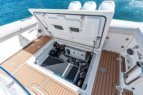  Yacht Photos Pics 2018 Boston Whaler 350 Outrage boat with open engine compartment, showcasing interior mechanics.